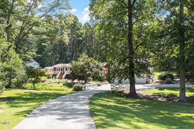 a front view of a house with yard and trees