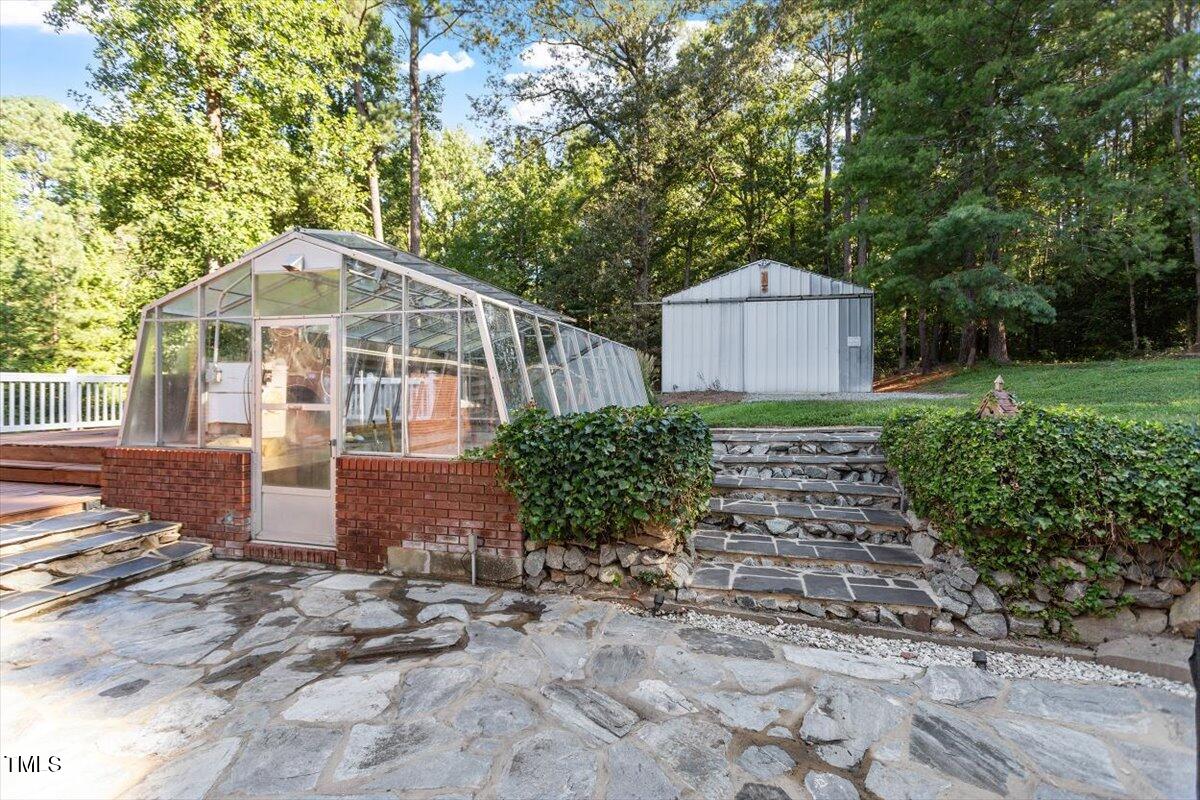 2129 Kelly Road Apex, NC 27502 - Photo 43 of 64 a front view of a house with garden