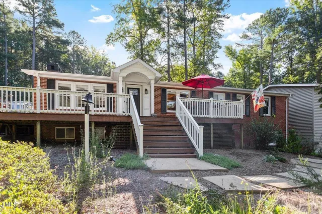 an aerial view of a house with swimming pool and large trees