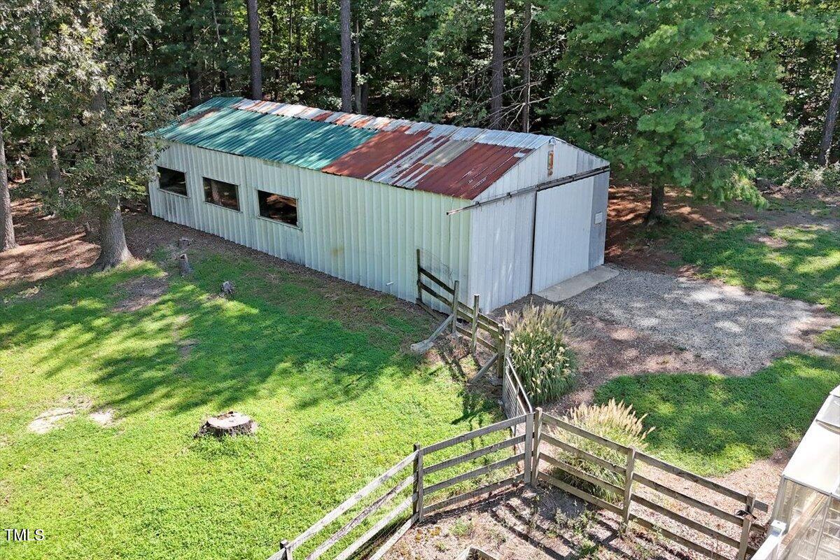 2129 Kelly Road Apex, NC 27502 - Photo 55 of 64 a view of backyard with a barn and a cactus plant