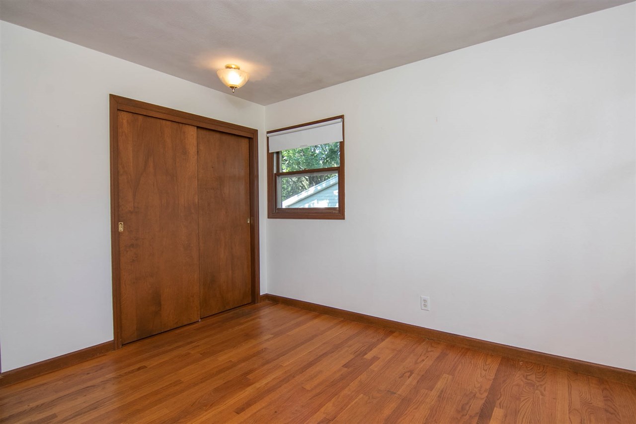 4861 Welsh Road Rockford, IL 61107 - Photo 12 of 21 an empty room with wooden floor and windows