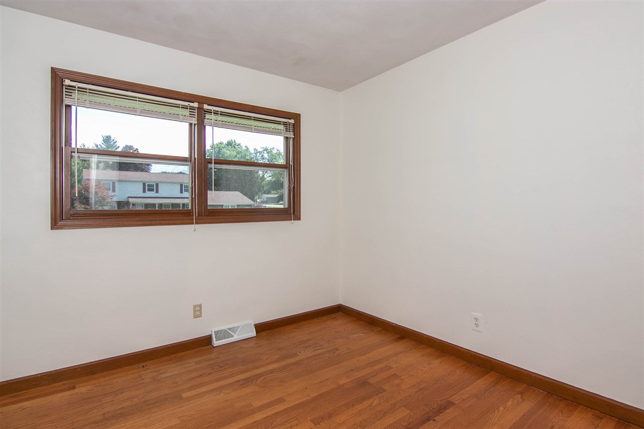 4861 Welsh Road Rockford, IL 61107 - Photo 13 of 21 wooden floor in an empty room with a window
