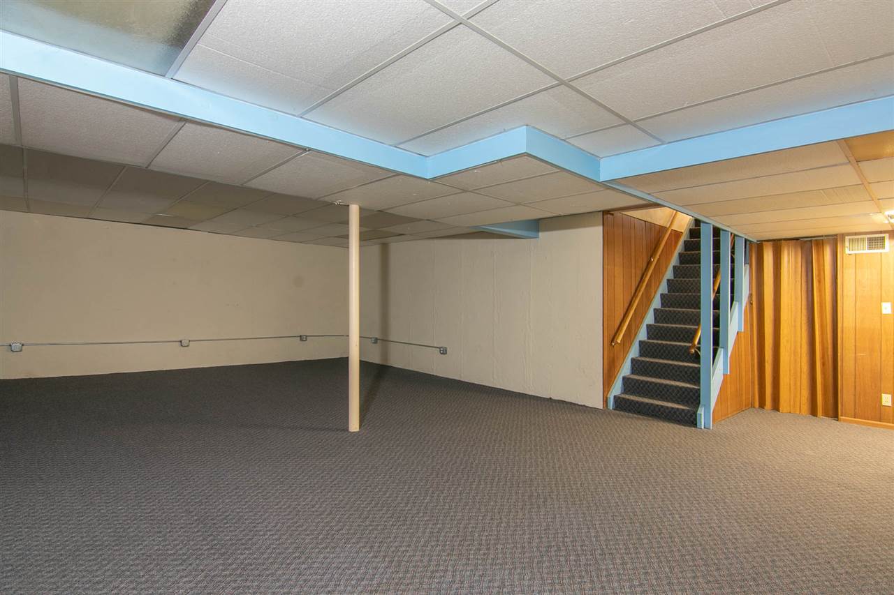 4861 Welsh Road Rockford, IL 61107 - Photo 16 of 21 a view of an empty room with stairs and furniture