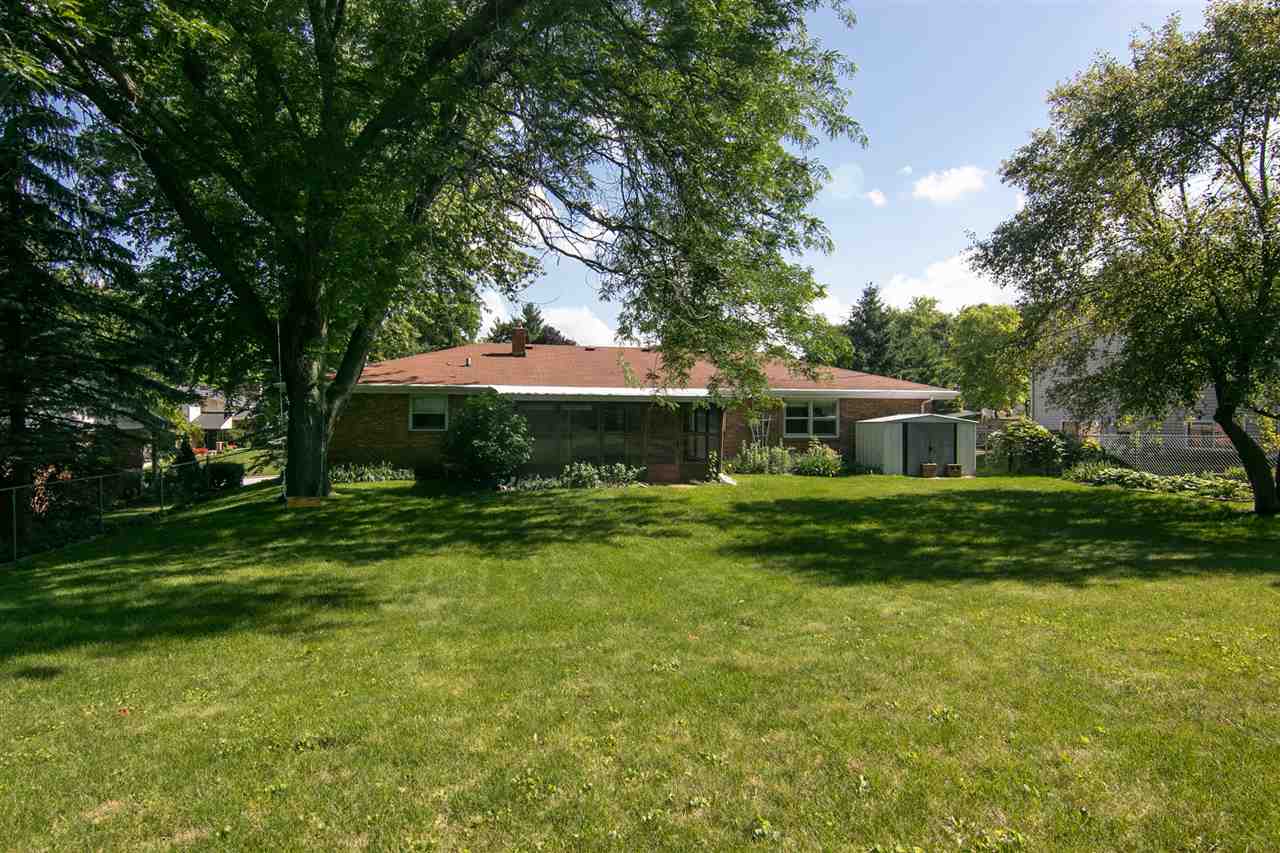 4861 Welsh Road Rockford, IL 61107 - Photo 20 of 21 a front view of a house with a garden and trees