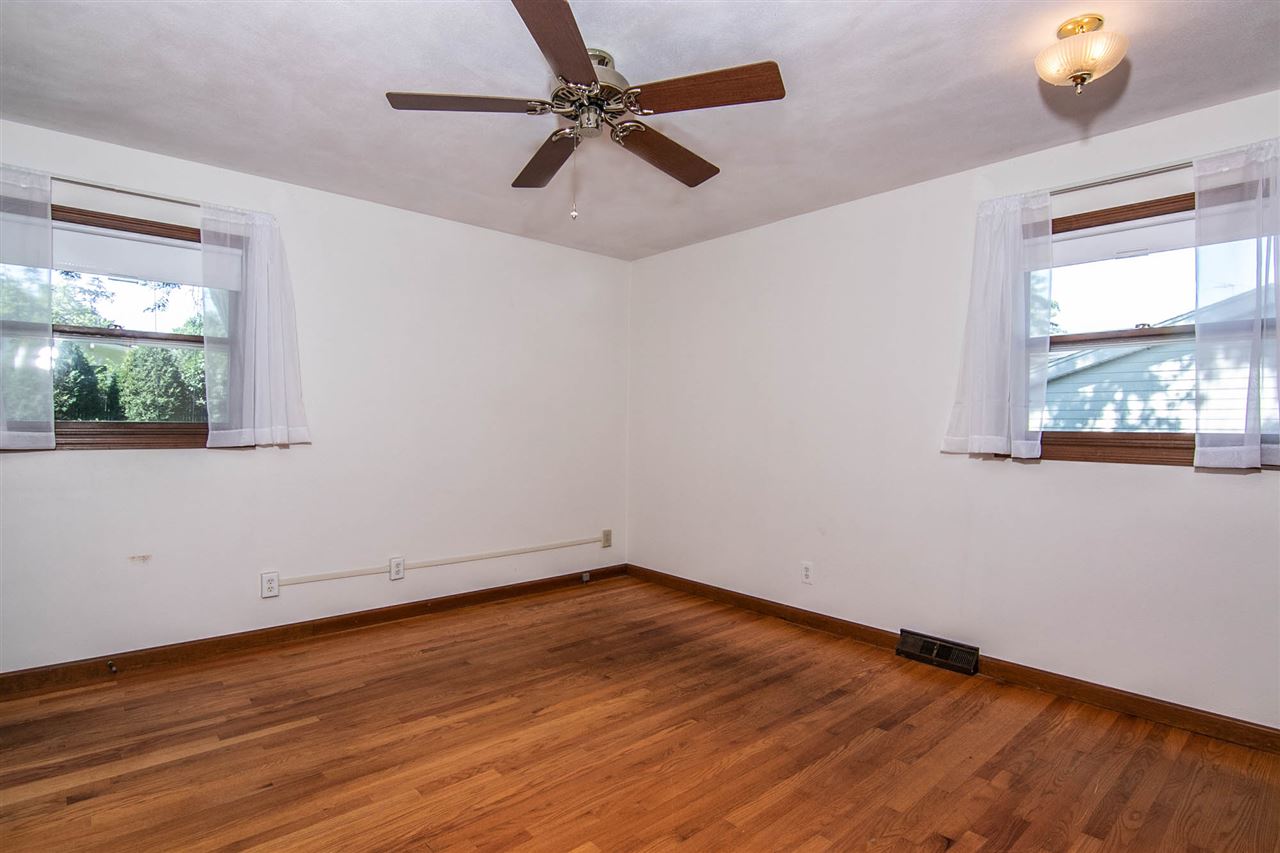 4861 Welsh Road Rockford, IL 61107 - Photo 10 of 21 a view of an empty room with wooden floor and a window