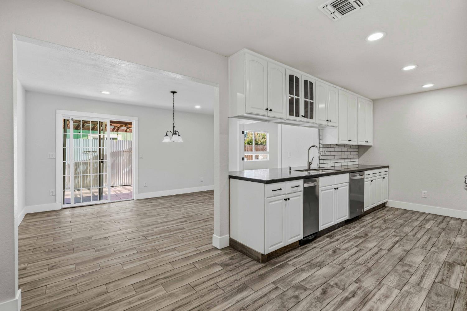1464 Denise Drive Ripon, CA 95366 - Photo 7 of 41 a kitchen with a sink cabinets and wooden floor