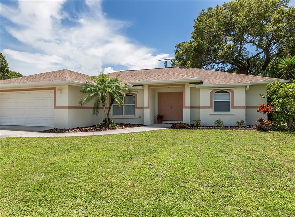 295 Coral Road Venice, FL 34293 - Photo 1 of 1 a front view of house with yard and green space