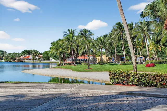 a bathroom with a granite countertop sink a toilet and bathtub