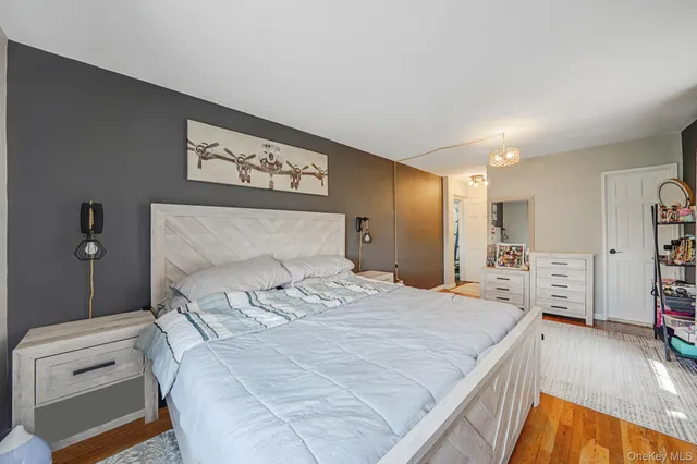 a bedroom with a bed and a television