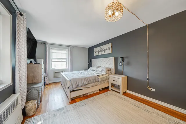 a bedroom with a bed and a tv on table