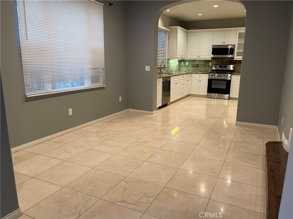 460 Santa Maria Street Anaheim, CA 92801 - Photo 4 of 5 a large kitchen with stainless steel appliances granite countertop a stove and a sink