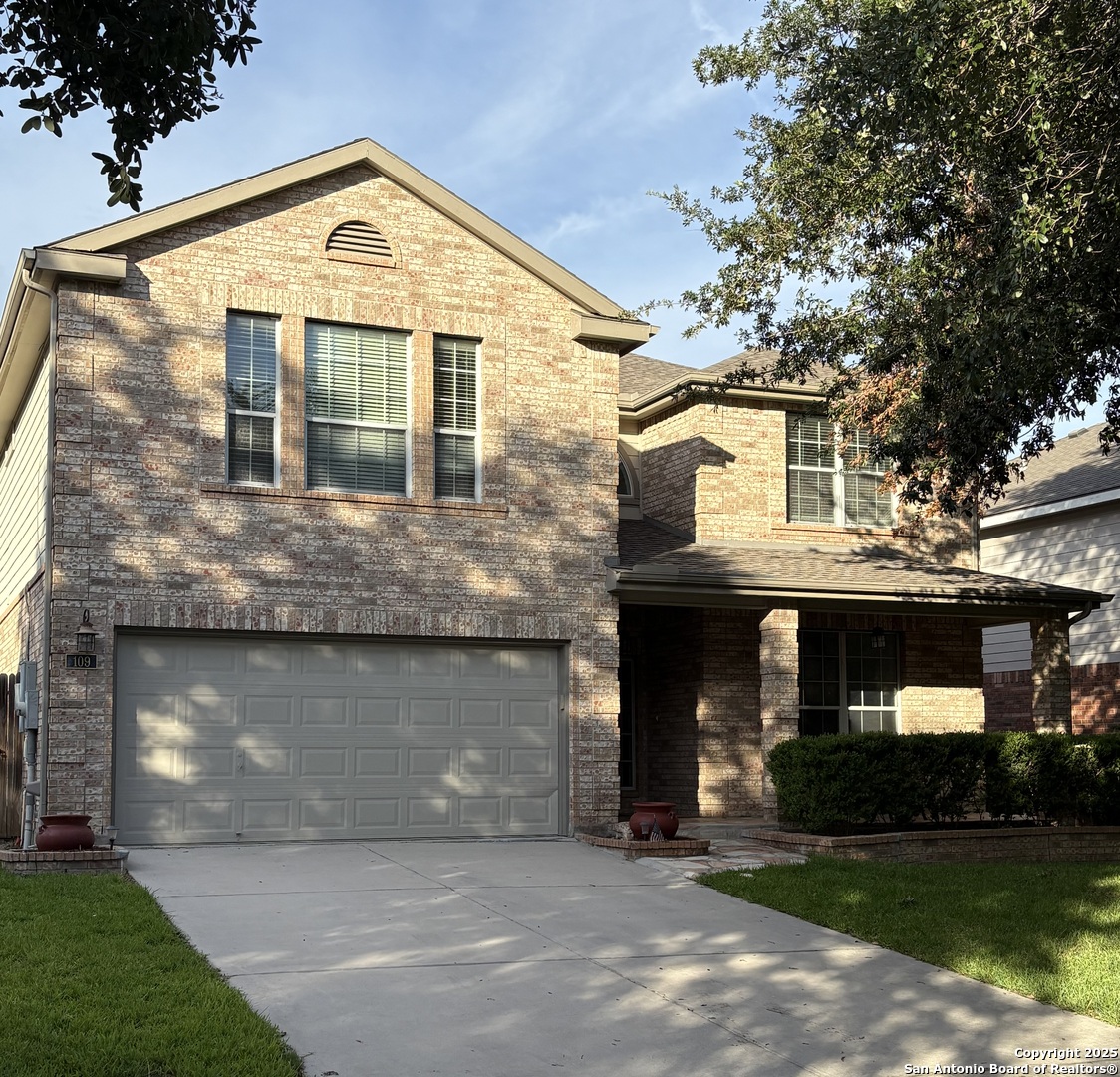 a front view of a house with a yard and garage