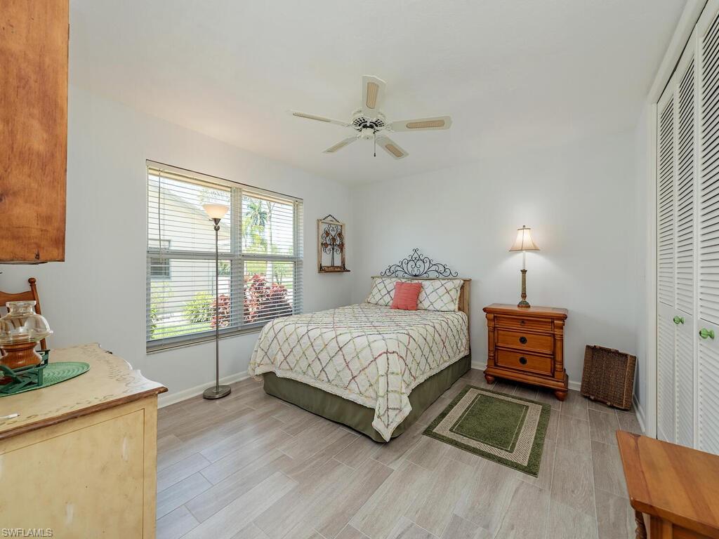 226 Torrey Pines Point Naples, FL 34113 - Photo 12 of 27 Bedroom with a closet, baseboards, light wood-style flooring, and a ceiling fan