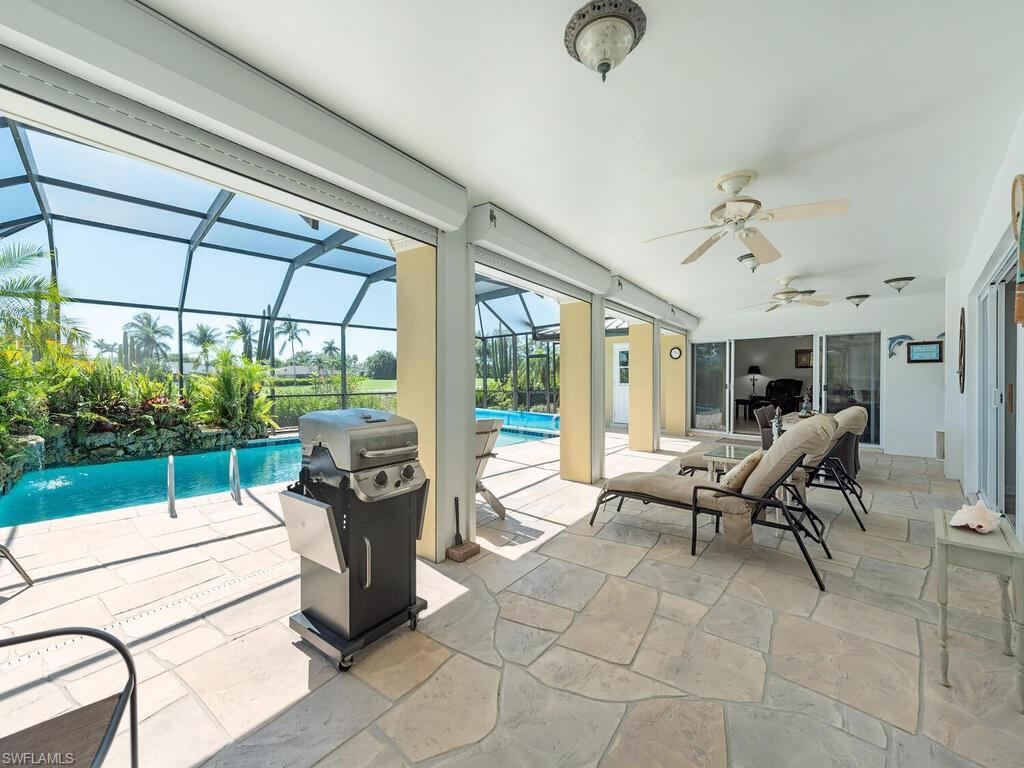 226 Torrey Pines Point Naples, FL 34113 - Photo 22 of 27 View of patio with a grill, ceiling fan, a lanai, and an outdoor pool