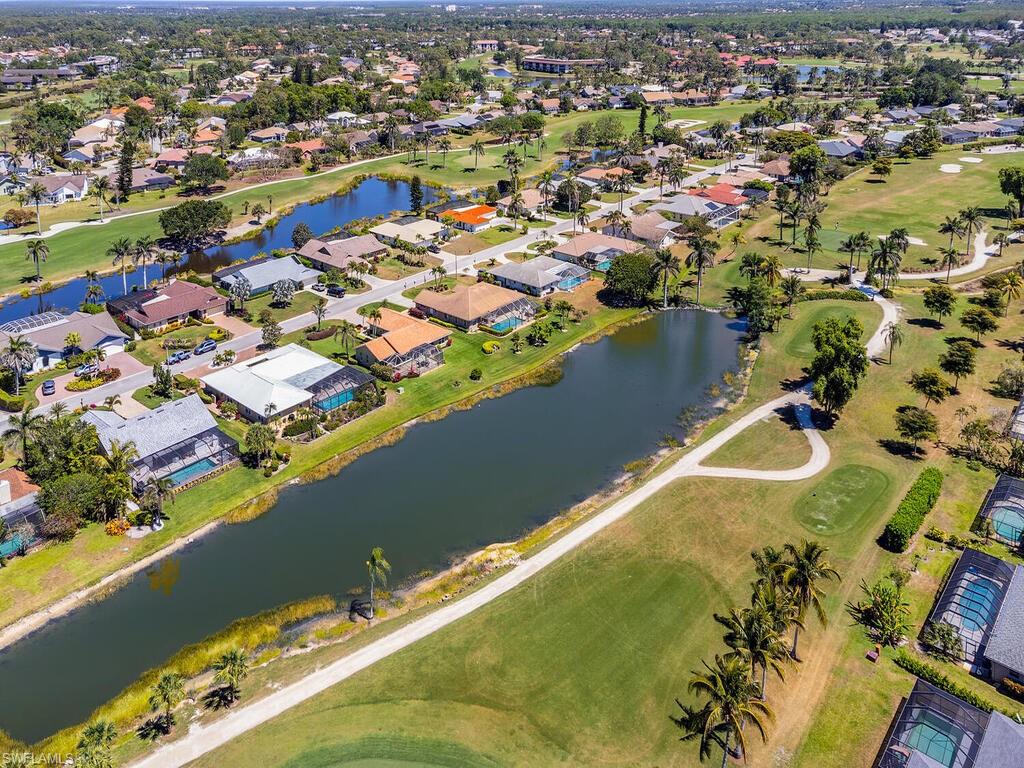 226 Torrey Pines Point Naples, FL 34113 - Photo 6 of 27 Drone / aerial view with a residential view, golf course view, and a water view