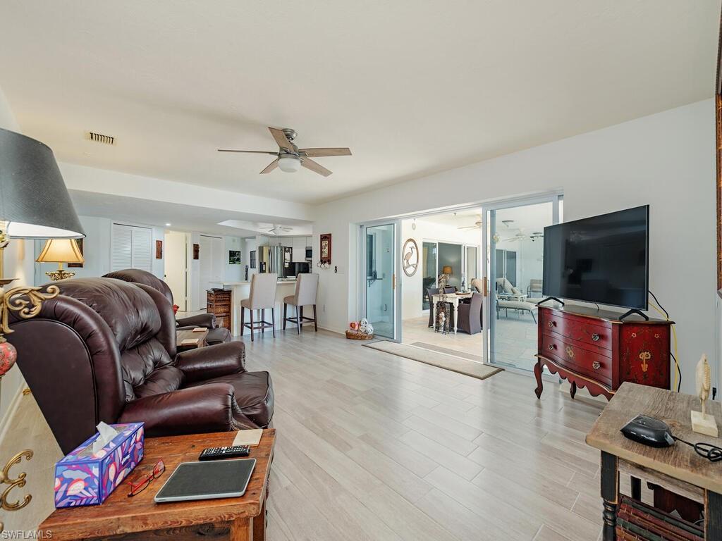 226 Torrey Pines Point Naples, FL 34113 - Photo 8 of 27 Living area featuring light wood finished floors, visible vents, and ceiling fan