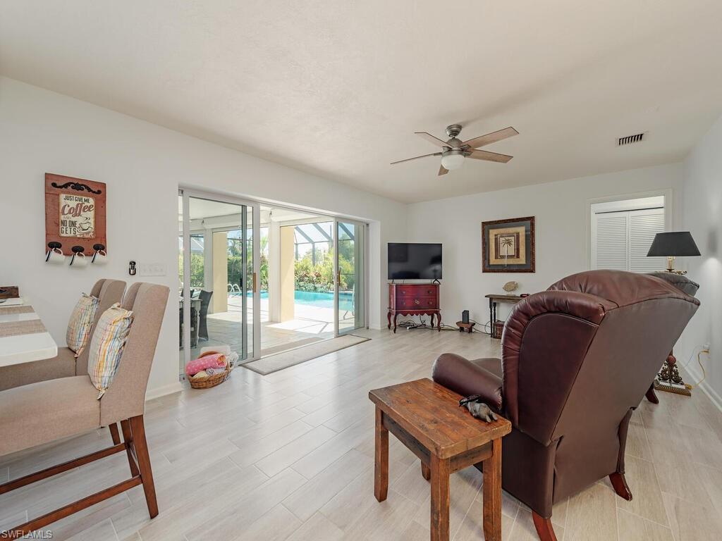 226 Torrey Pines Point Naples, FL 34113 - Photo 9 of 27 Living area with a ceiling fan and visible vents