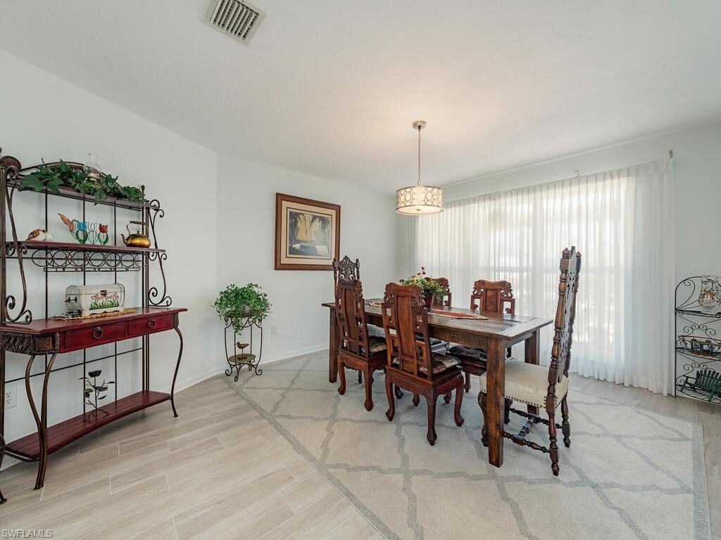 226 Torrey Pines Point Naples, FL 34113 - Photo 10 of 27 Dining room featuring baseboards, visible vents, and light wood-type flooring
