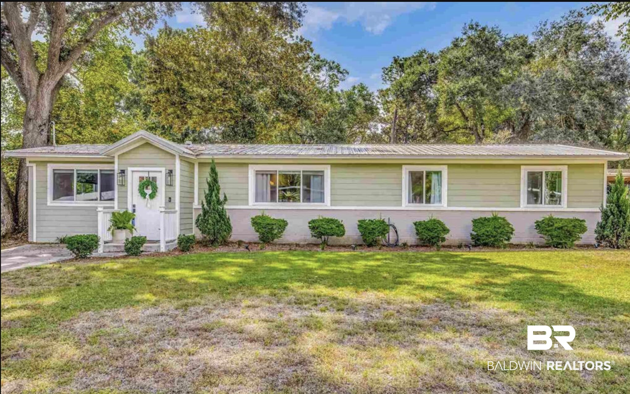 3275 Adrian Road Pensacola, FL 32504 - Photo 1 of 1 Single-story home featuring light green horizontal siding and a white entry porch with a gable roof