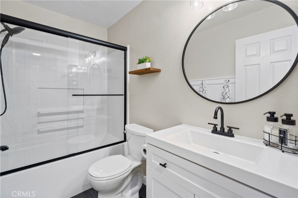 8520 Lake Knoll Avenue, Unit B Garden Grove, CA 92844 - Photo 13 of 31 a bathroom with a sink mirror toilet and vanity