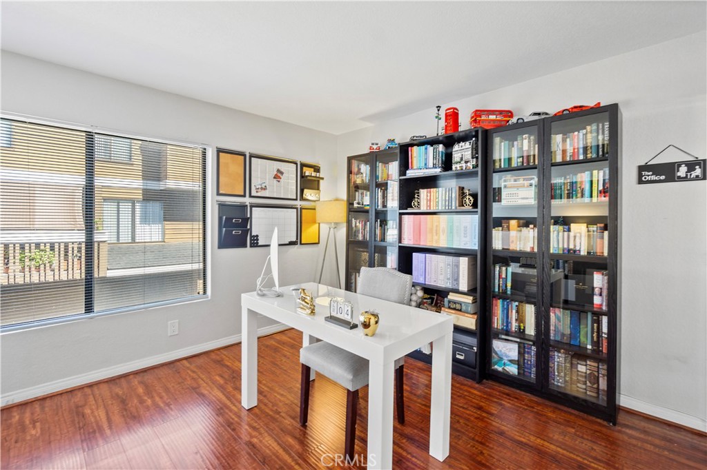 8520 Lake Knoll Avenue, Unit B Garden Grove, CA 92844 - Photo 14 of 31 a living room with a book shelf and a wooden floor
