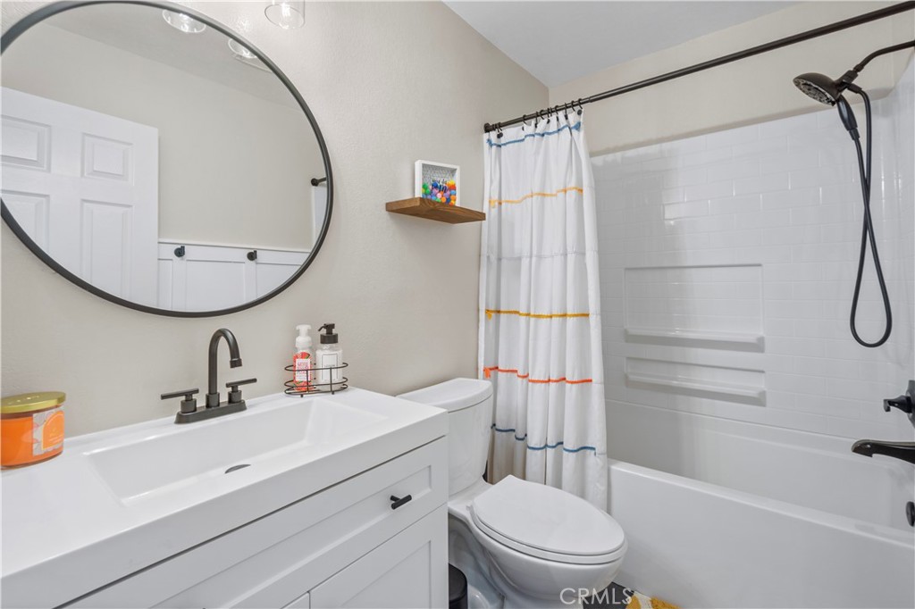 8520 Lake Knoll Avenue, Unit B Garden Grove, CA 92844 - Photo 19 of 31 a bathroom with a sink a toilet and shower