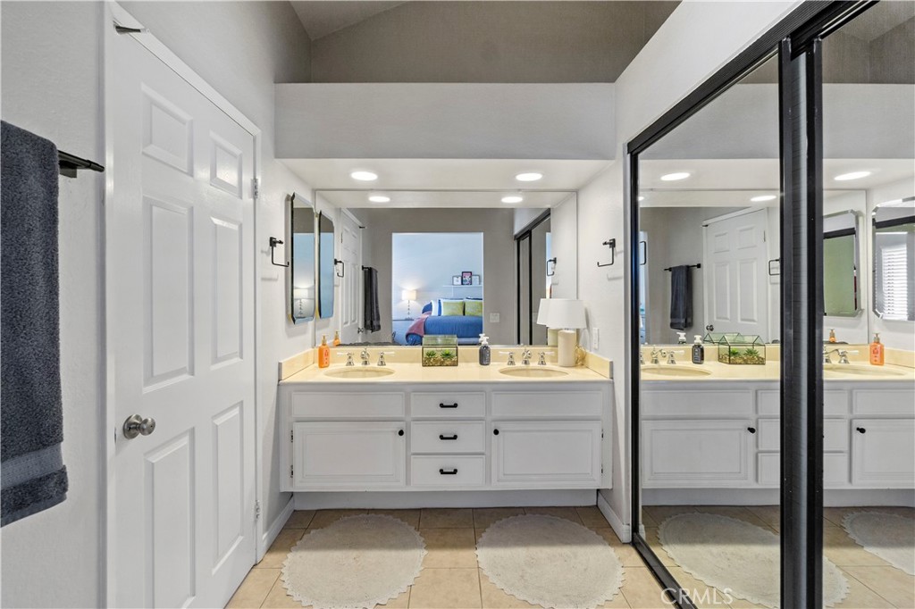 8520 Lake Knoll Avenue, Unit B Garden Grove, CA 92844 - Photo 24 of 31 a large bathroom with a glass door shower a sink a mirror and a bathtub