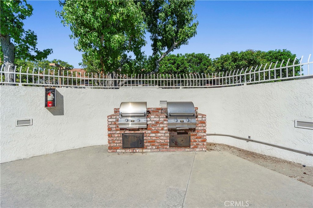 8520 Lake Knoll Avenue, Unit B Garden Grove, CA 92844 - Photo 29 of 31 a view of terrace with wooden fence and trees