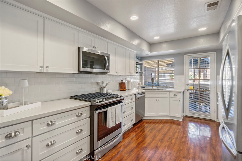 8520 Lake Knoll Avenue, Unit B Garden Grove, CA 92844 - Photo 10 of 31 a kitchen with sink a stove and cabinets