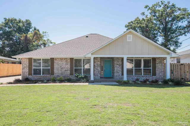 a front view of a house with a garden and porch