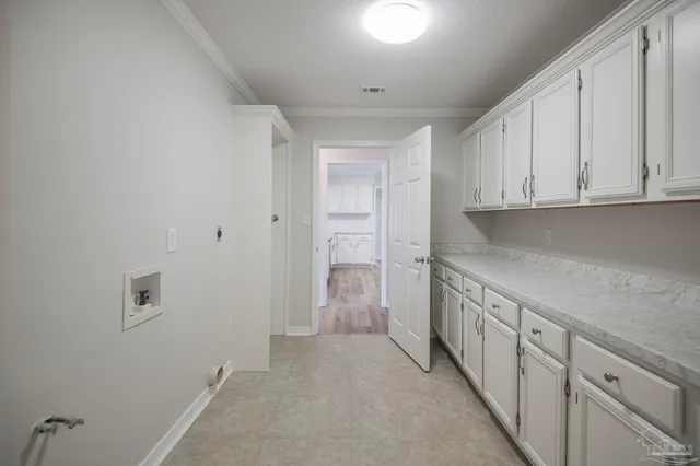 a view of a kitchen with white cabinets