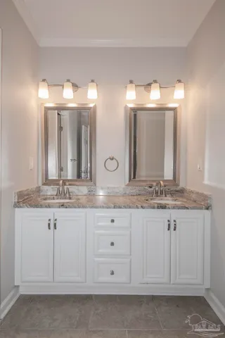 a bathroom with double sink and a mirror