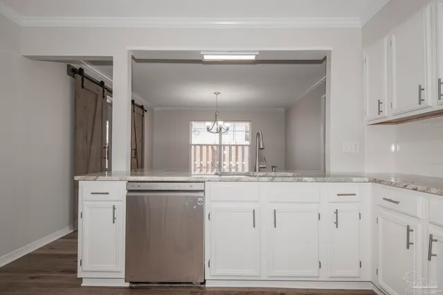 a kitchen with granite countertop white cabinets and white appliances