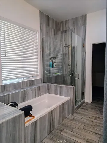 a bathroom with a granite countertop sink and a bathtub