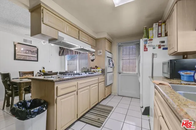 a kitchen with stainless steel appliances granite countertop a stove and a sink