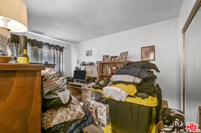 a bed room with a bed and a chair