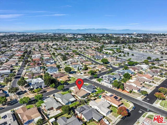 an aerial view of a house with a yard and large trees