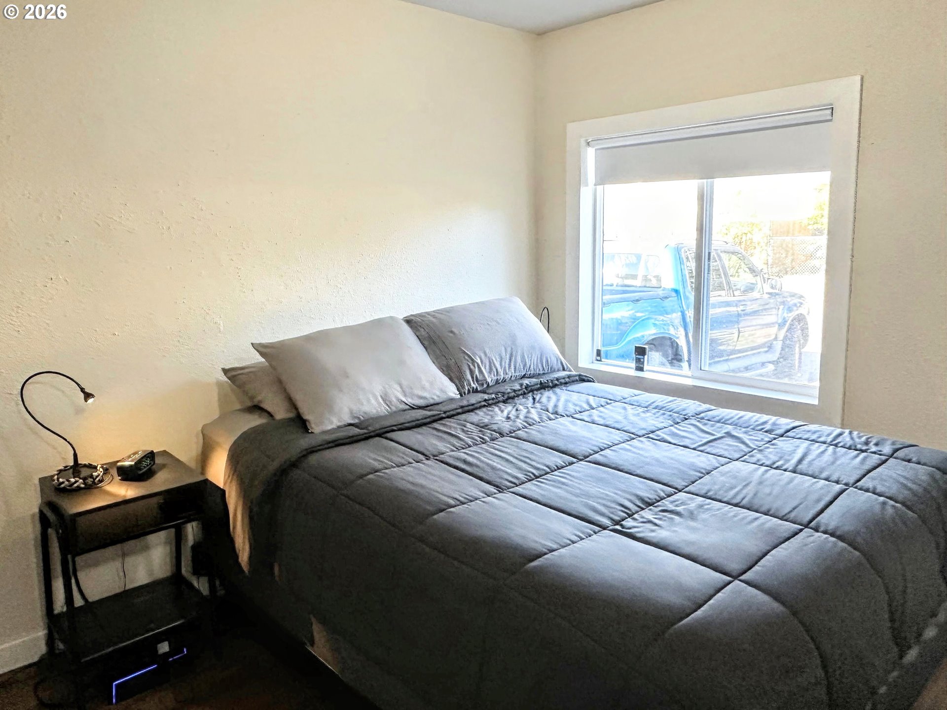 11818 Northeast Holladay Street Portland, OR 97230 - Photo 10 of 26 a bedroom with a bed and a window