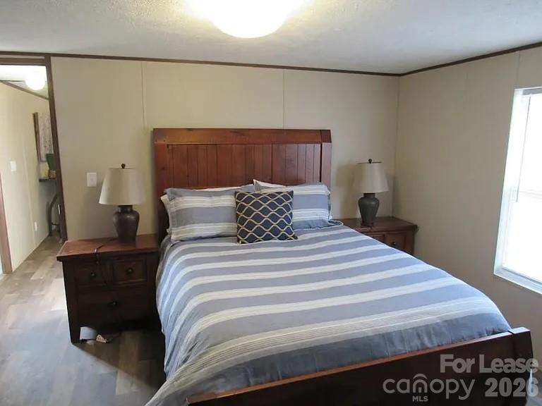 3182 Pea Ridge Road Mill Spring, NC 28756 - Photo 2 of 5 a bedroom with a bed and window