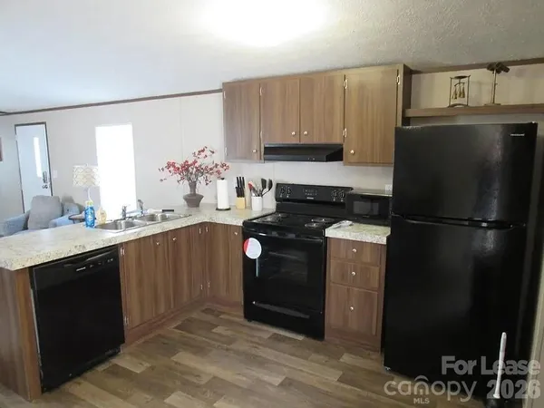 a kitchen with a refrigerator stove and sink