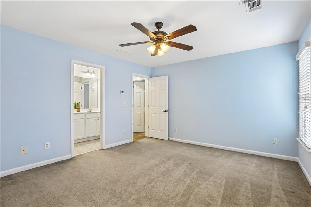 810 Freedom Way Cumming, GA 30040 - Photo 35 of 61 a view of an empty room with a ceiling fan