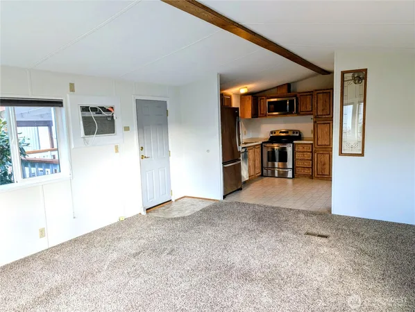 an empty room with closet and a window