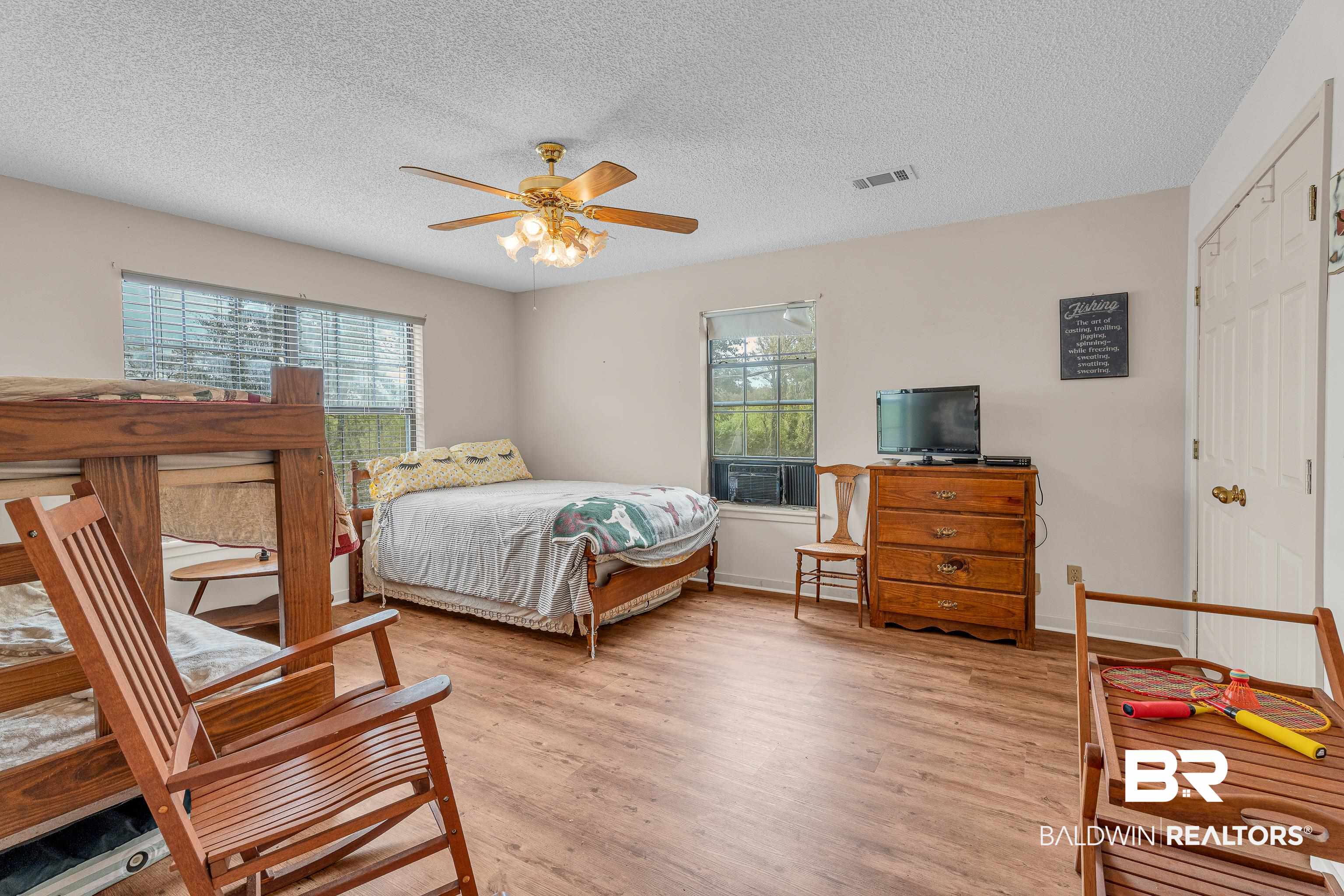 8317 Bryant's Lndg Road Stockton, AL 36579 - Photo 20 of 28 Bedroom with light wood-style floors, a textured ceiling, a closet, and ceiling fan
