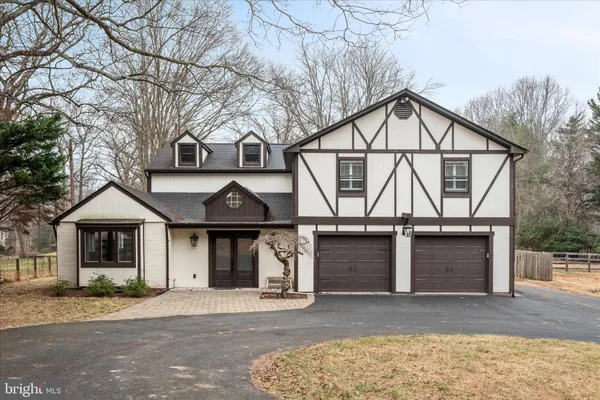a front view of a house with a garage and a yard