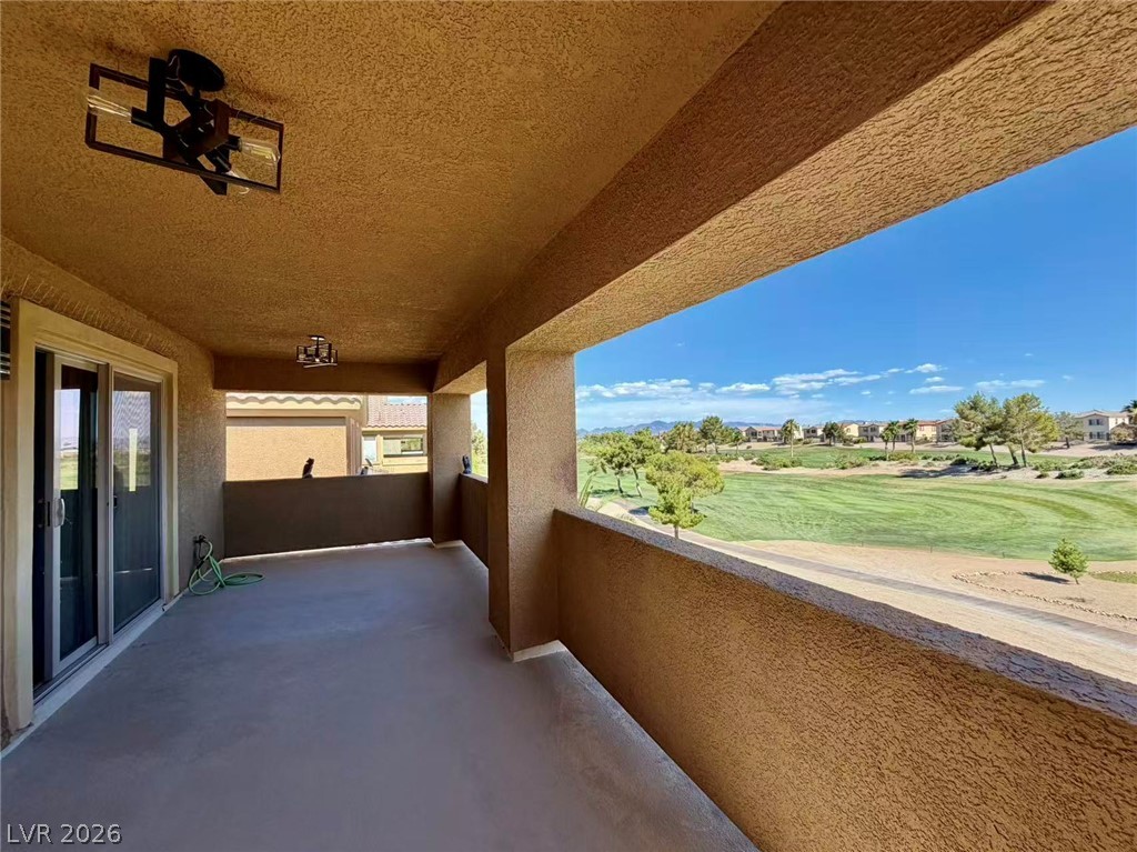 135 Tall Ruff Drive Las Vegas, NV 89148 - Photo 19 of 29 Unwind on this spacious covered patio, offering serene views of the verdant golf course and distant mountains.