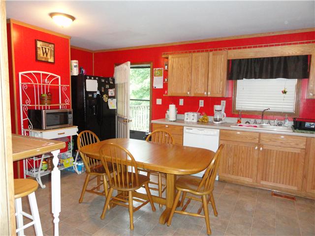 9360 Hodge Road Mount Pleasant, TN 38474 - Photo 7 of 20 Eat-In Kitchen has plenty of cabinets and counter space. Kitchen has window which overlooks the Living Room.