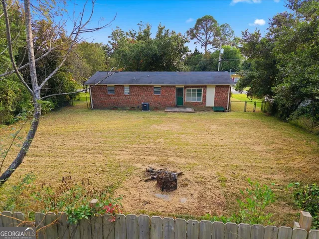an aerial view of a residential houses with yard