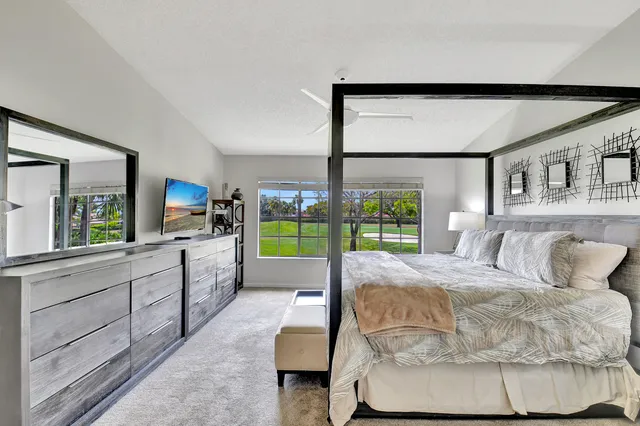 a bed room with a bed and a television