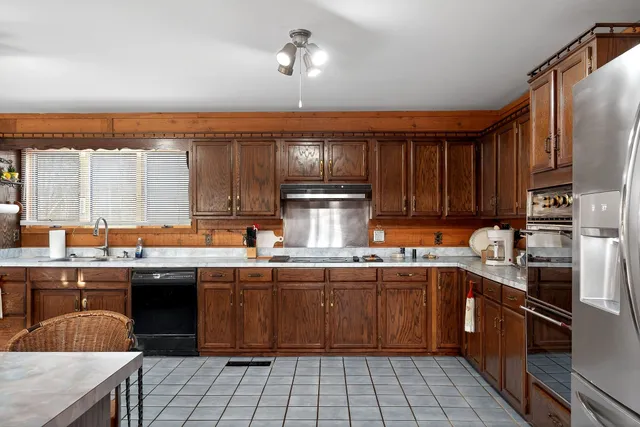 a kitchen with a sink a stove and cabinets