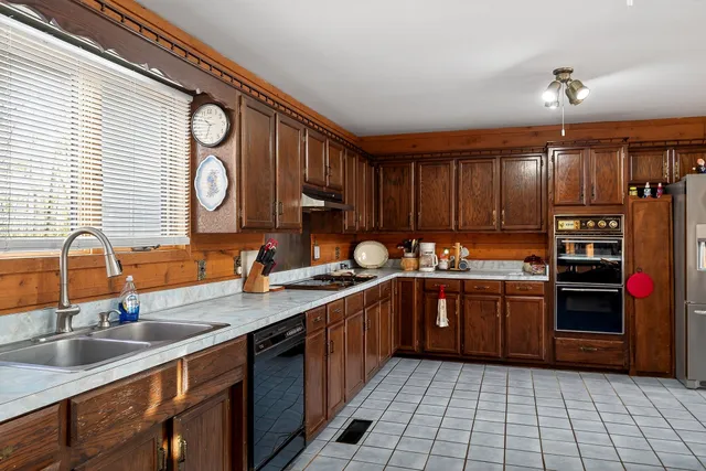 a kitchen with stainless steel appliances granite countertop a sink and cabinets
